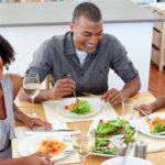 Smiling,Family,Dining,Together,In,The,Kitchen