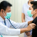 Senior,Asian,Doctor,Examining,Male,Patient,In,The,Hospital.doctor,Listening