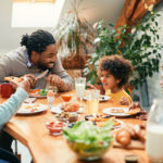 Happy,Black,Parents,And,Their,Kids,Talking,While,Having,Breakfast