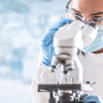 Female,Lab,Technician,In,Protective,Glasses,,Gloves,And,Face,Mask