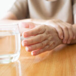 Elderly,Woman,Hands,W/,Tremor,Symptom,Reaching,Out,For,A