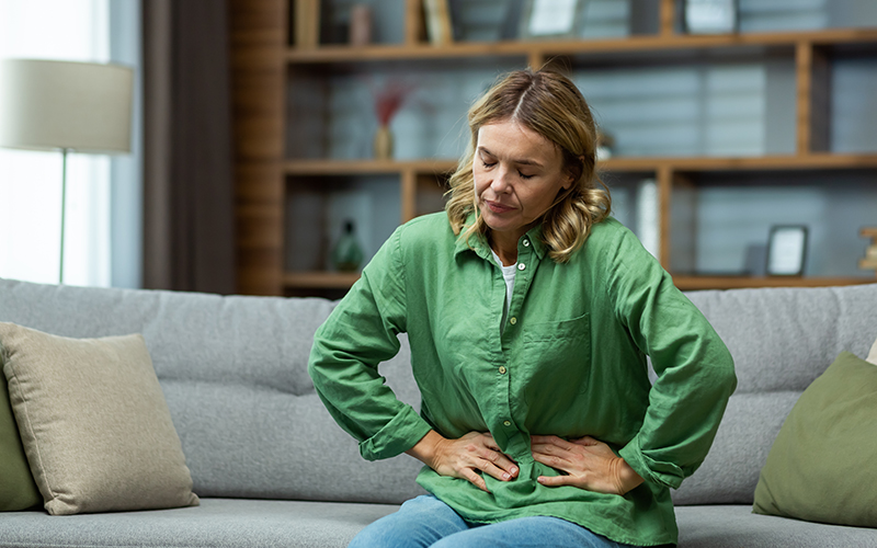 An,Elderly,Woman,Is,Sitting,On,The,Sofa,At,Home,