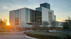Exterior shot of the Valley Medical Center hospital building with the sun setting behind it